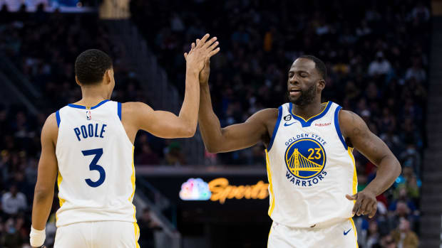Golden State Warriors guard Jordan Poole (3) and forward Draymond Green (23) celebrate after Poole drew a foul against the Brooklyn Nets during the first half at Chase Center.